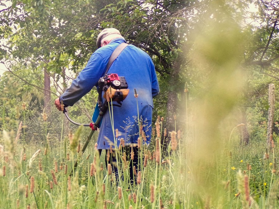 Persona usando una motoguadaña en el campo